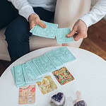 Practitioner providing an oracle card reading
